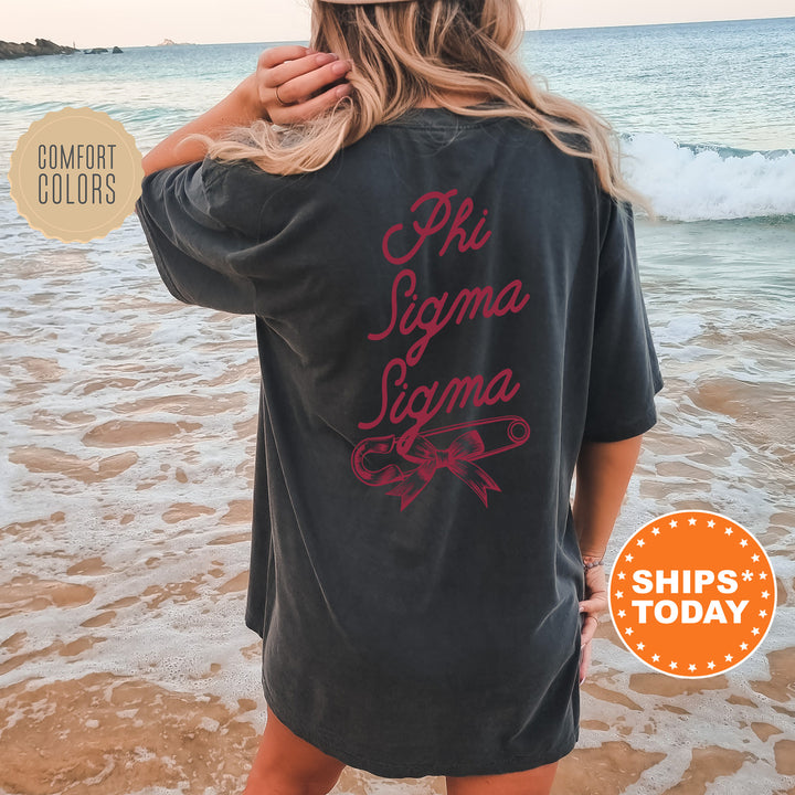a woman standing on a beach wearing a black shirt