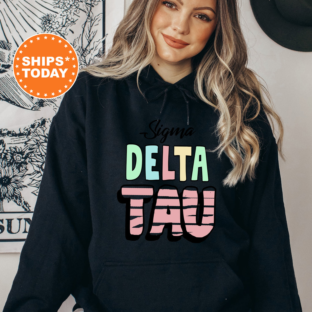 a woman wearing a black delta tau hoodie