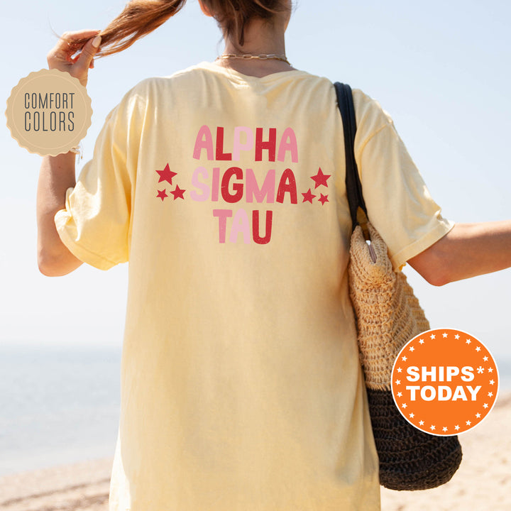 a woman is walking on the beach with her hair in a ponytail