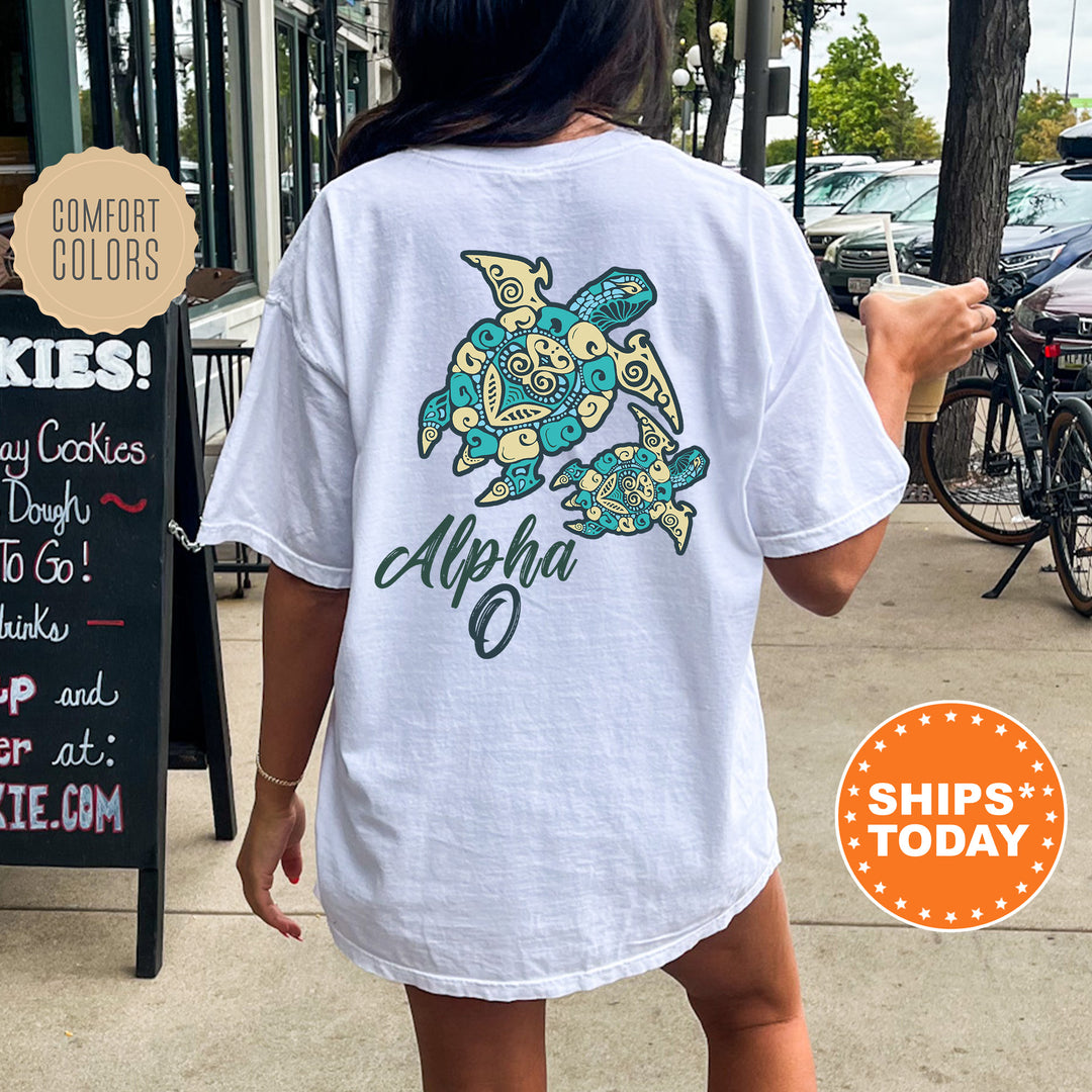 A person wearing a white t-shirt with a turtle design is walking on a sidewalk.