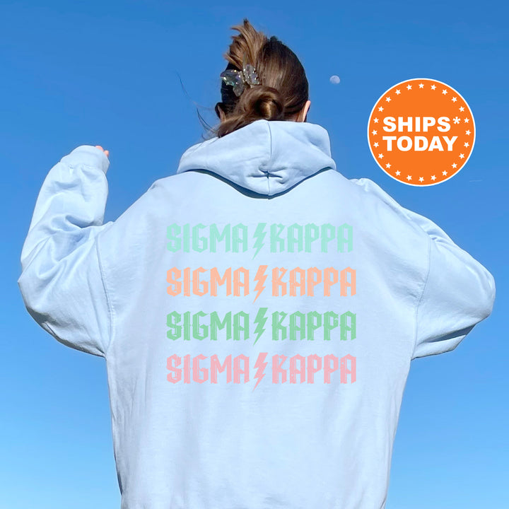a woman wearing a white hoodie with colorful letters on it