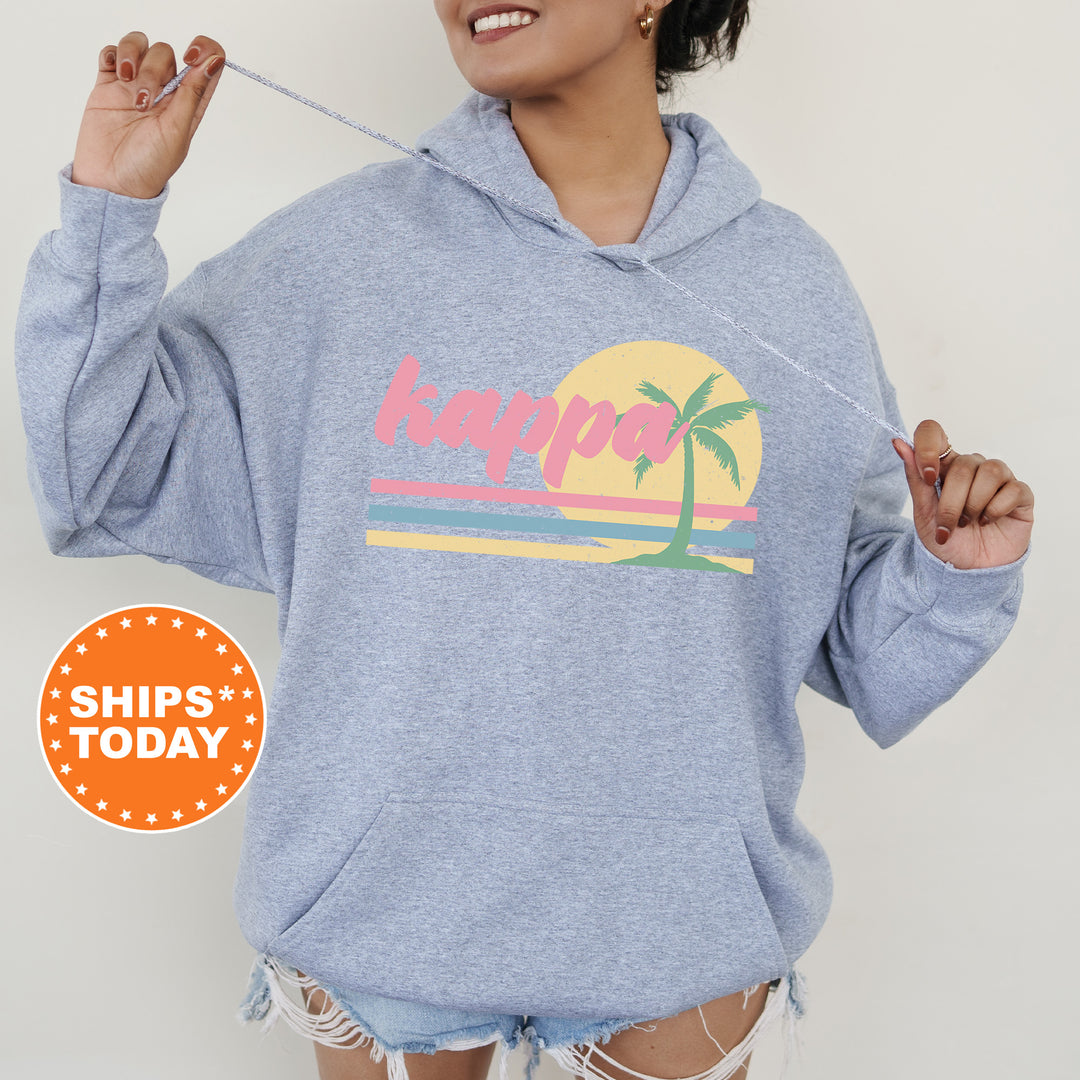 a woman wearing a blue sweatshirt with a palm tree on it