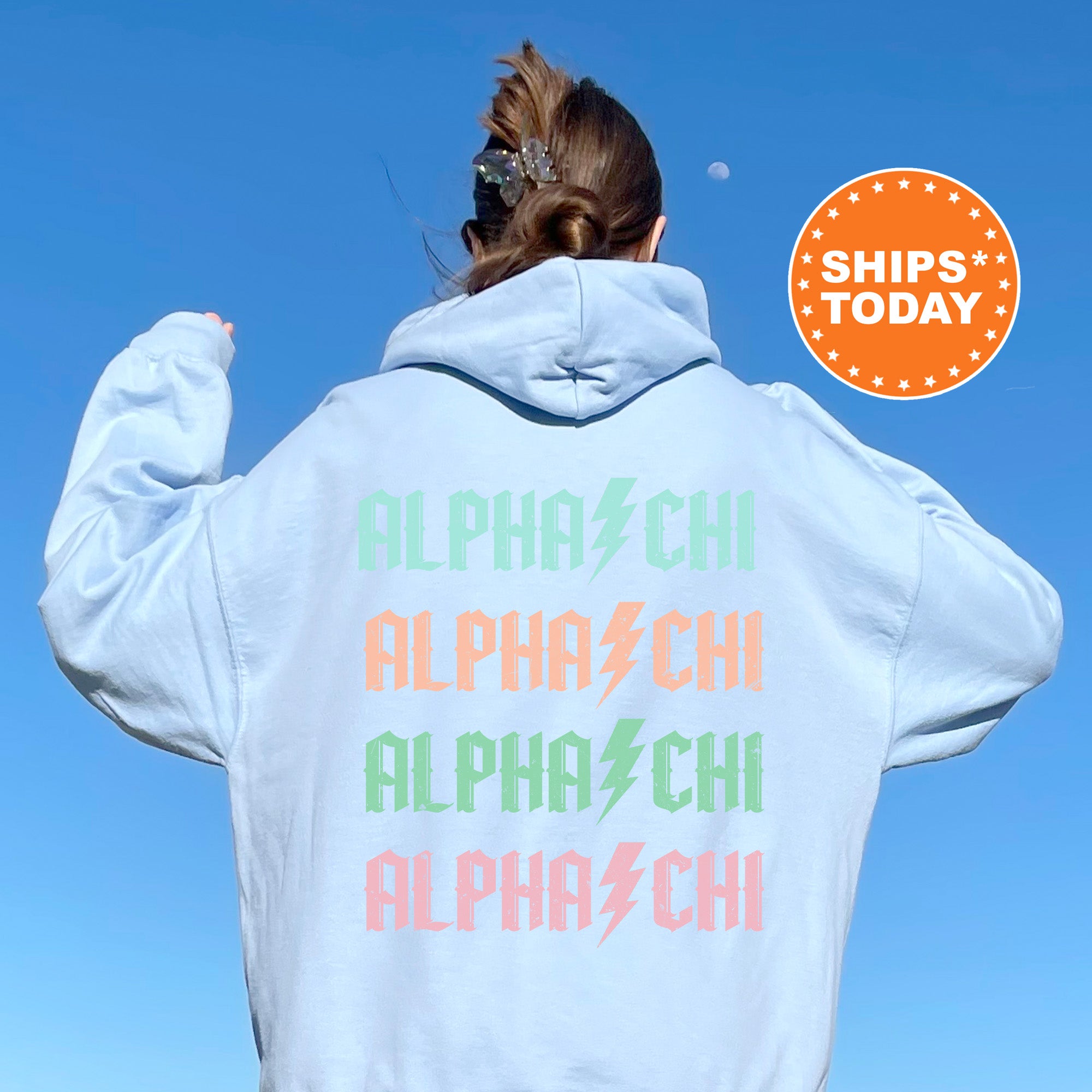 a woman wearing a white hoodie with the words alphabet printed on it