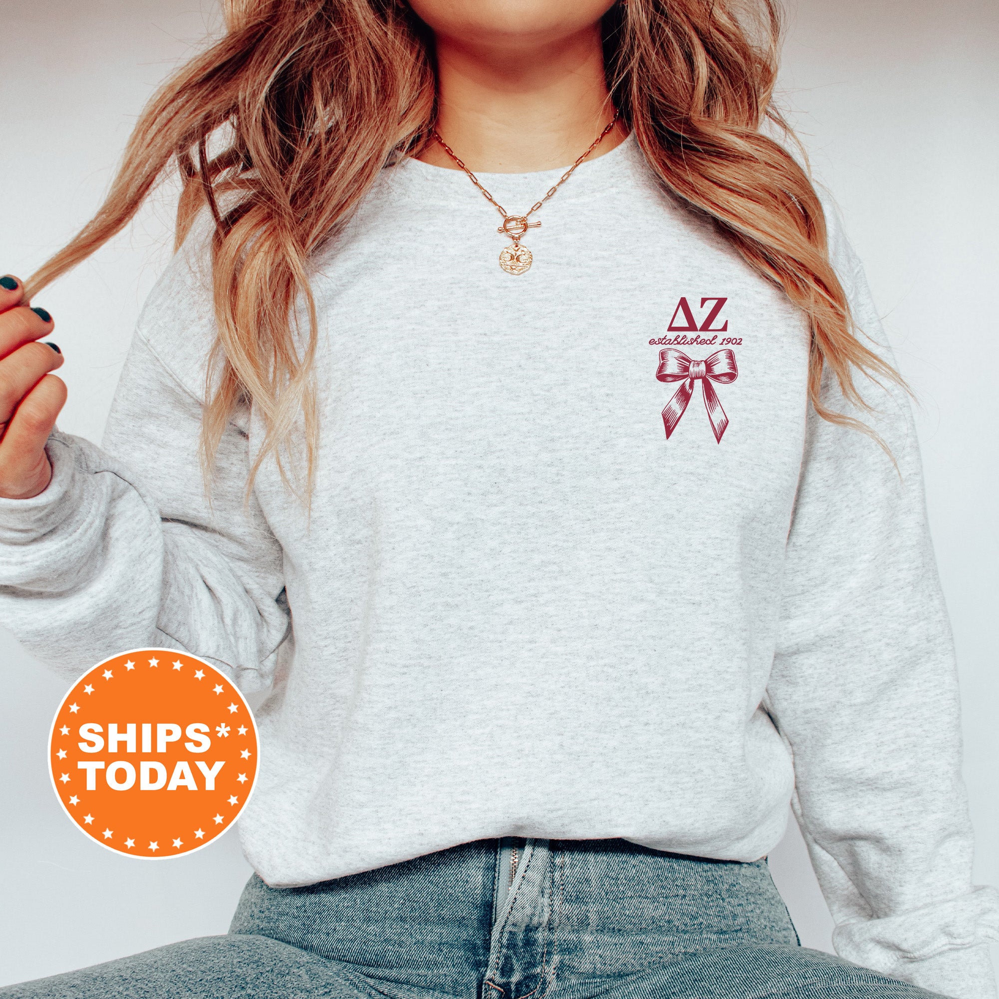 a woman wearing a sweatshirt with a cross on it