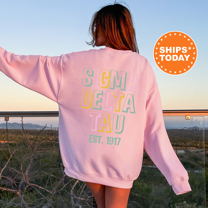 a woman in a pink sweatshirt is walking in the desert