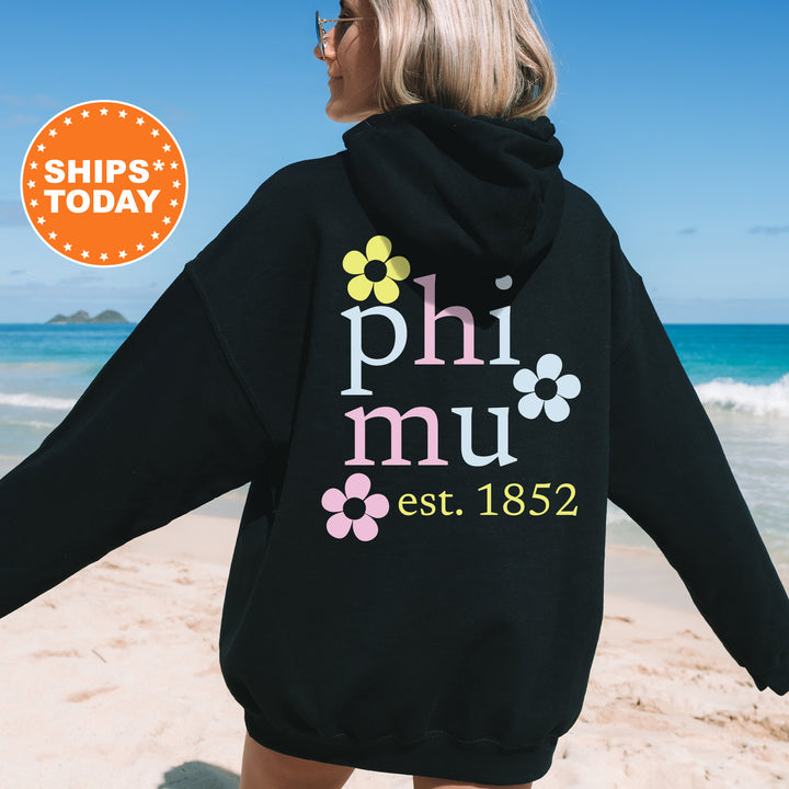 a woman in a black hoodie on the beach