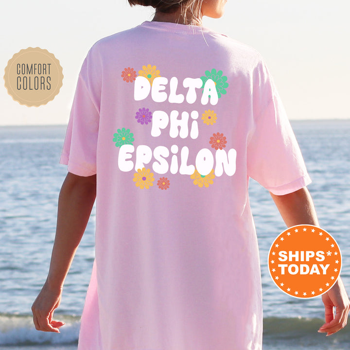 a woman wearing a pink shirt that says delta phi epsilon