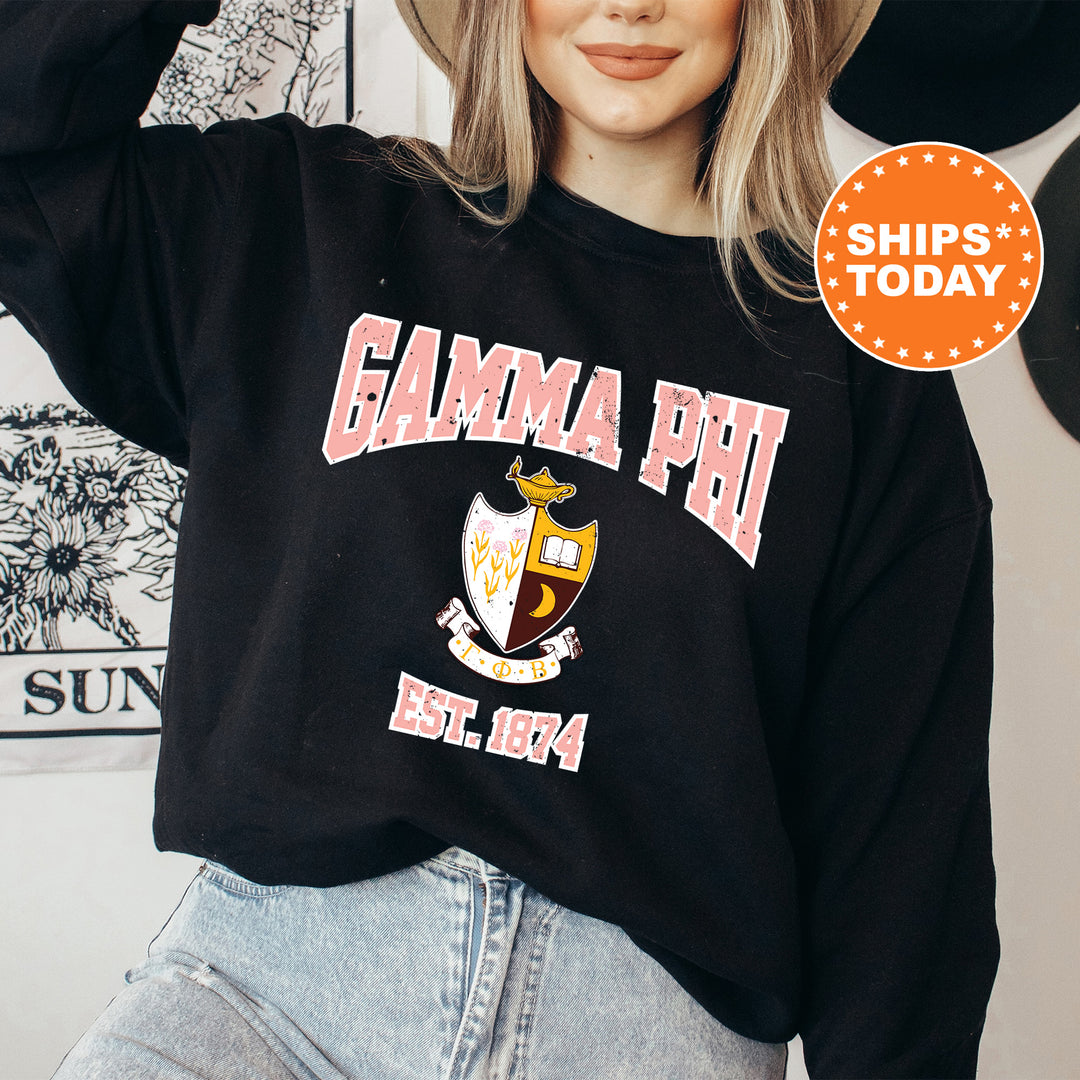 a woman wearing a black sweatshirt with the words gama phi on it