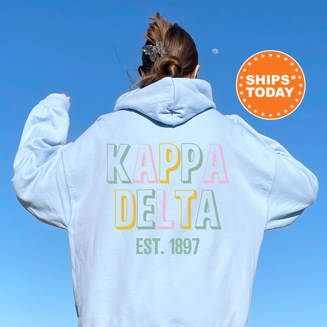a woman wearing a white hoodie with the words kappa delta on it