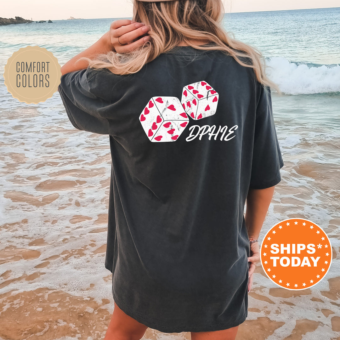 a woman standing on a beach wearing a black shirt