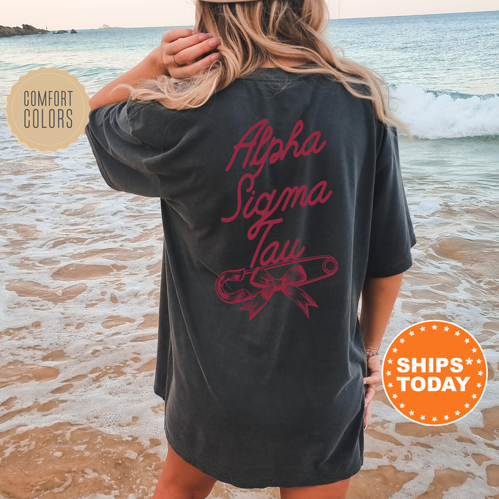 a woman standing on a beach wearing a black shirt