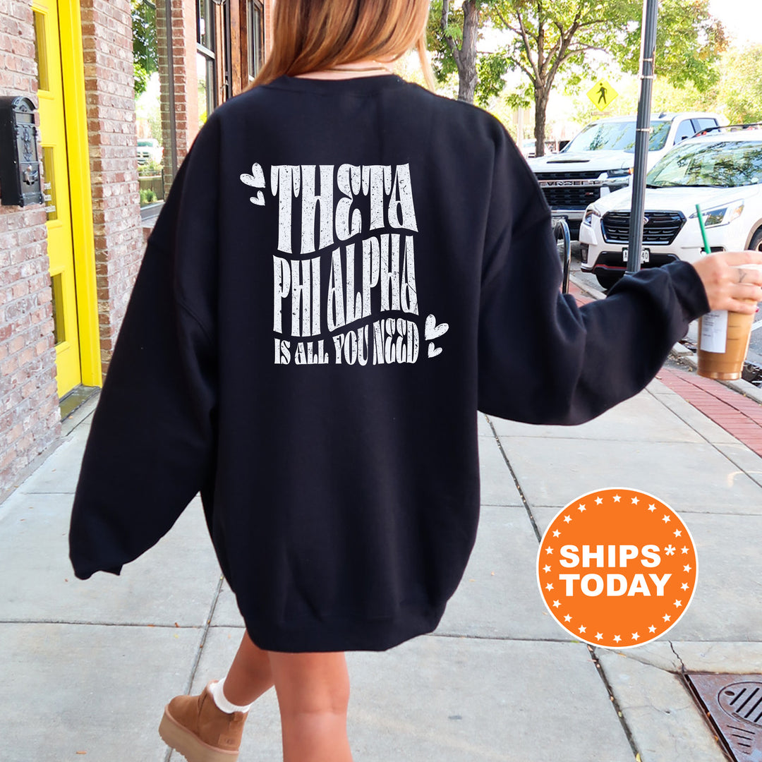 a woman walking down a sidewalk wearing a sweatshirt