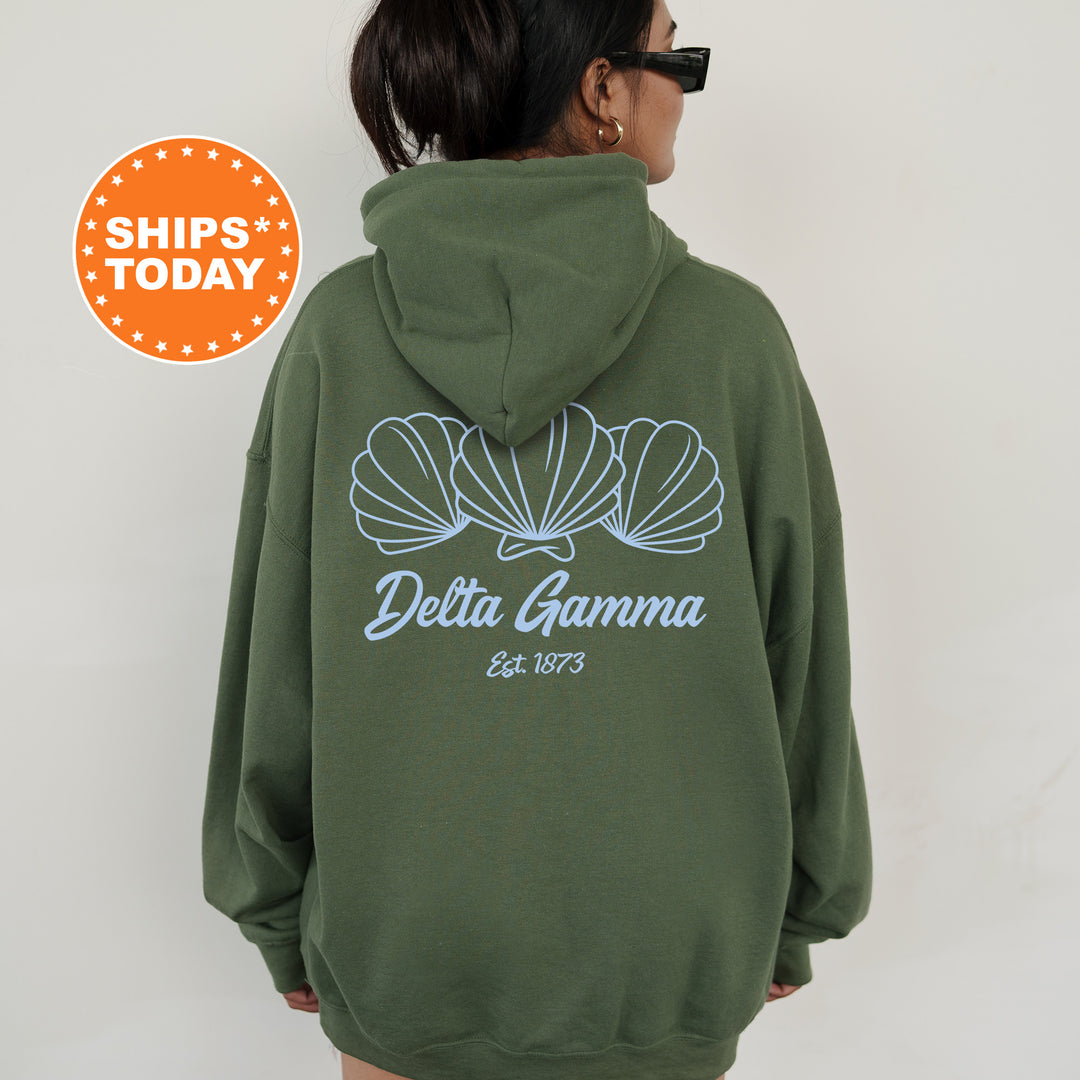 A person wearing a green hoodie with a graphic design and text on the back.