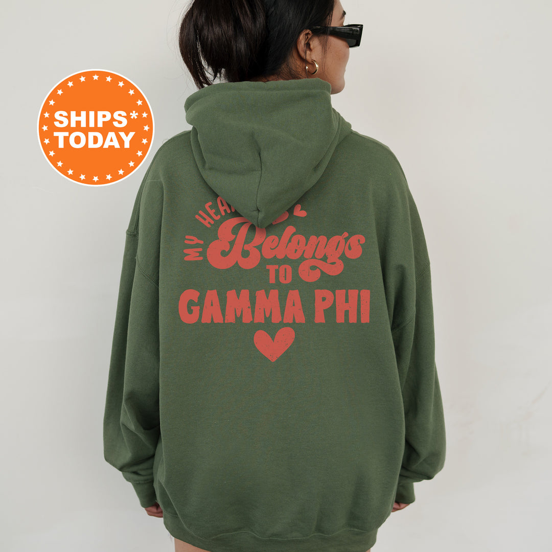 a woman wearing a green hoodie that says we belong to gama phi