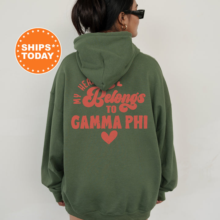 a woman wearing a green hoodie that says we belong to gama phi