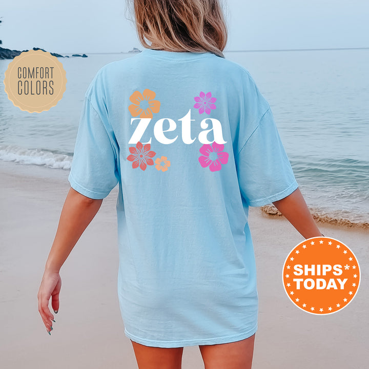 a woman walking on the beach wearing a zeta t - shirt