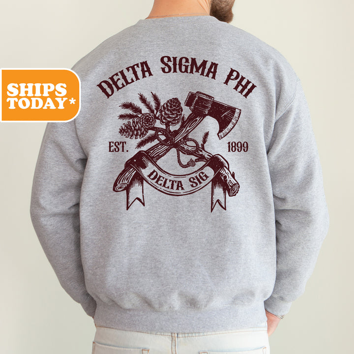the back of a man wearing a sweatshirt with an image of a hammer and pine