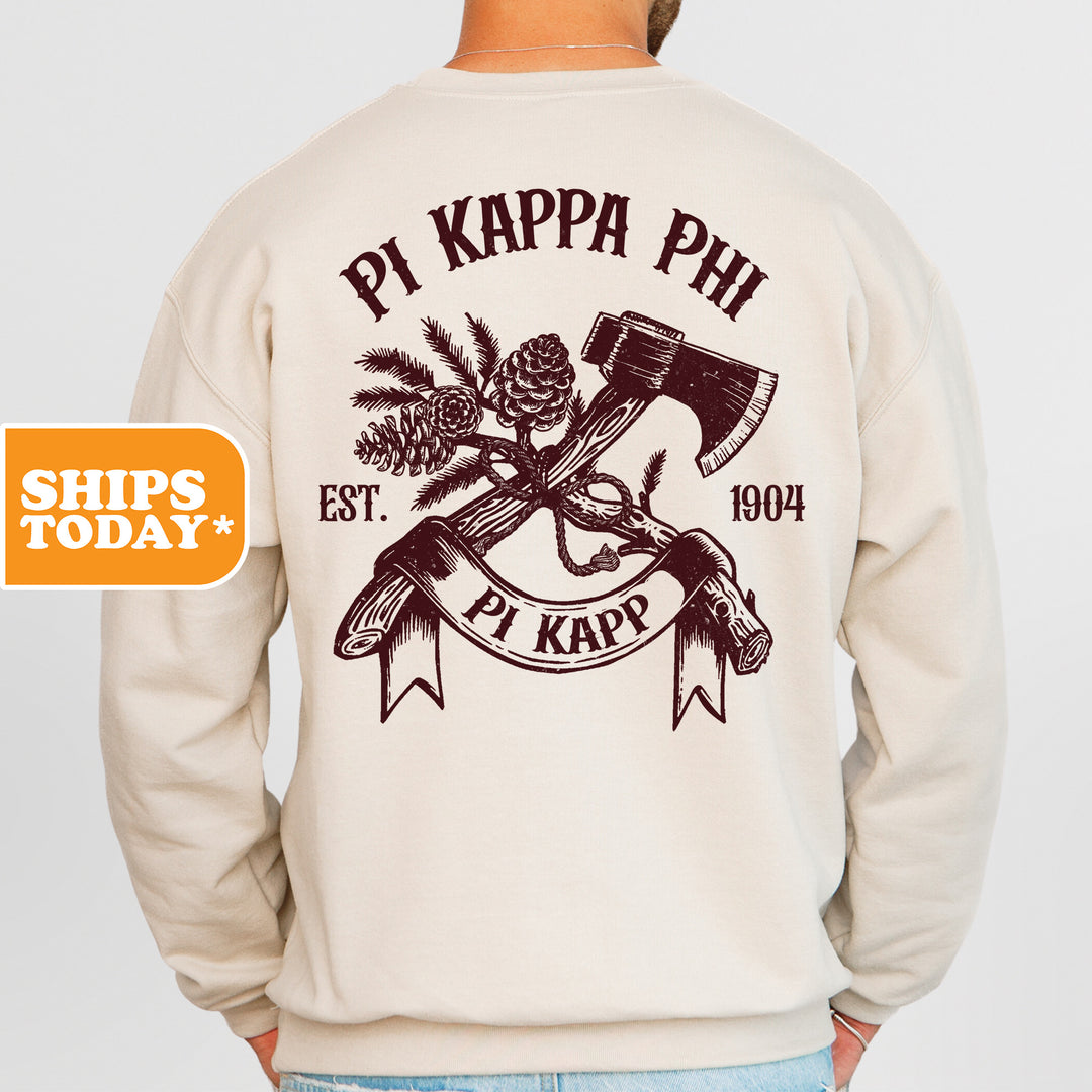 a man wearing a sweatshirt with an image of a hammer and pine cones on it