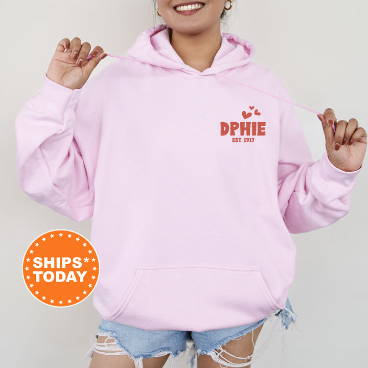 a woman wearing a pink hoodie with the words phi phi on it