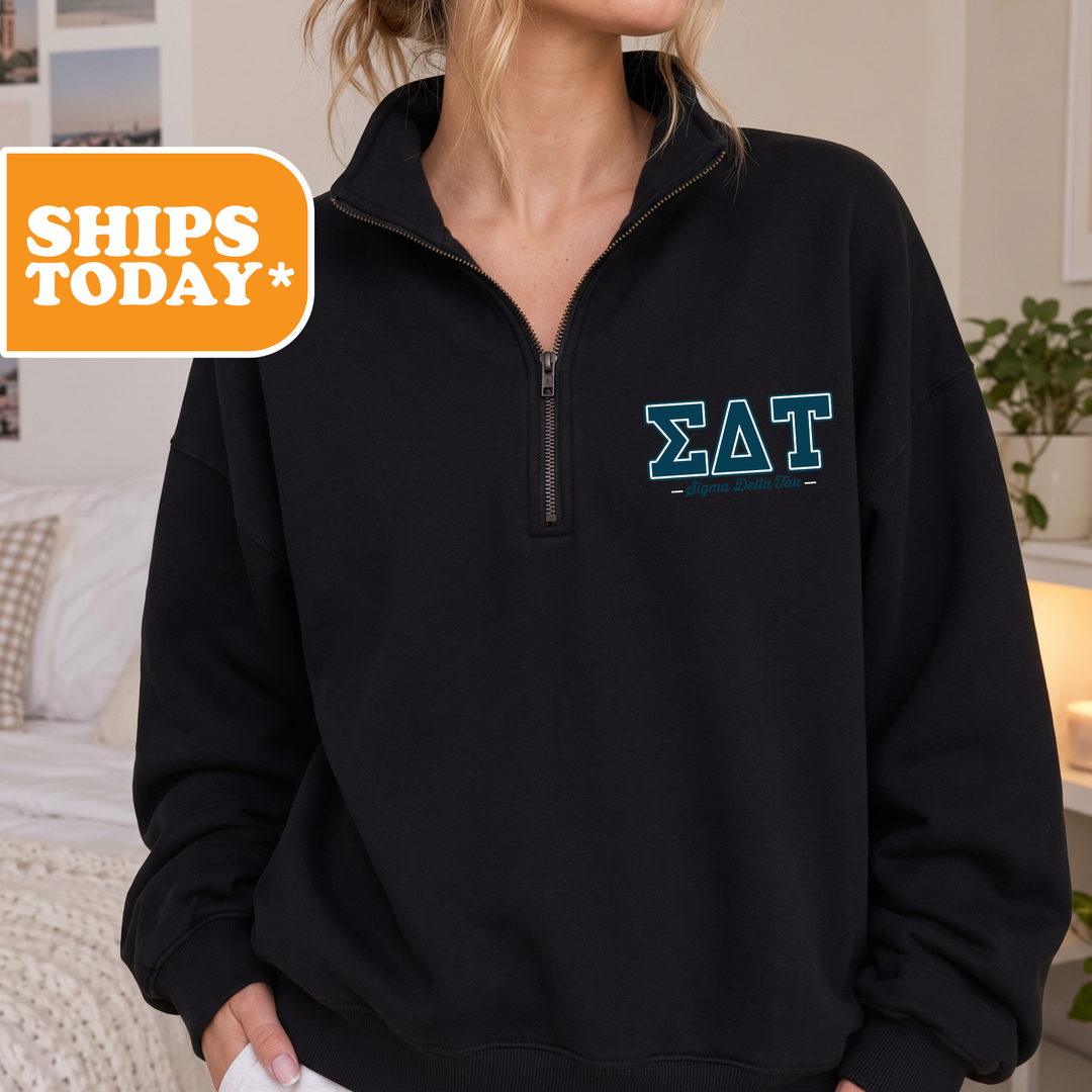 A person wearing a black sweatshirt with the Sigma Delta fraternity logo on the front.