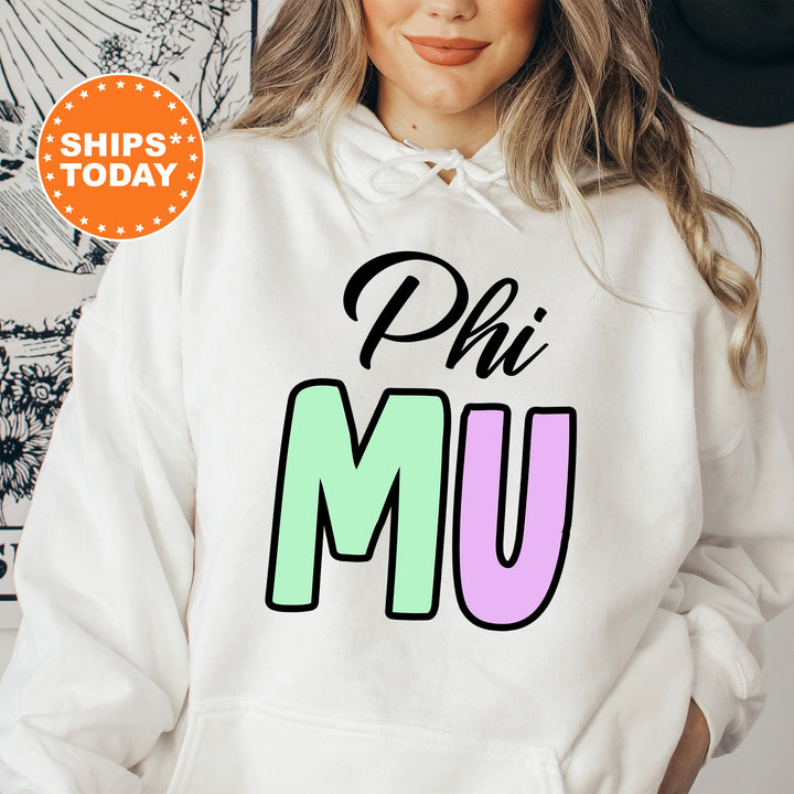 a woman wearing a white phi mu hoodie