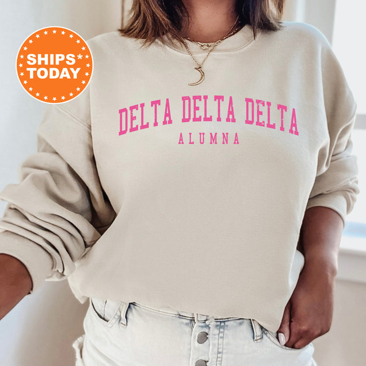 a woman wearing a sweatshirt that says delta delta delta