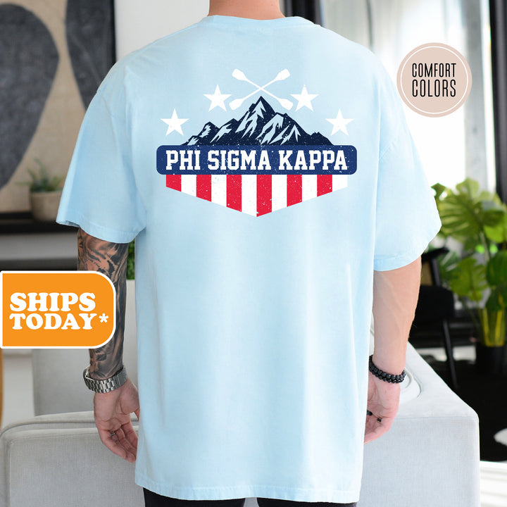 a man wearing a blue shirt with a red, white and blue design on it