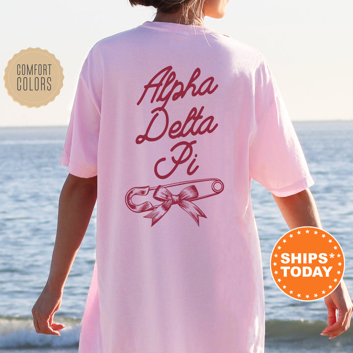 a woman wearing a pink shirt that says aloha delta pi