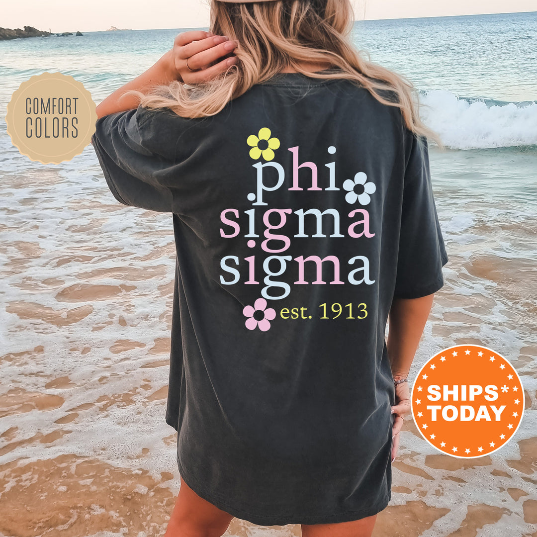 a woman standing on a beach wearing a shirt that says phi sigma si