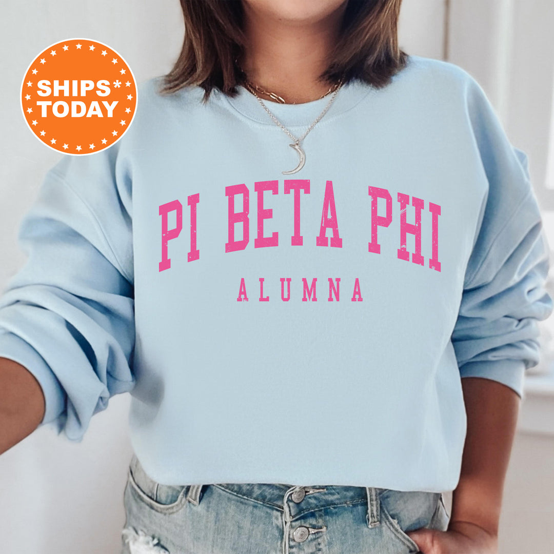 a woman wearing a blue sweatshirt with pink letters on it