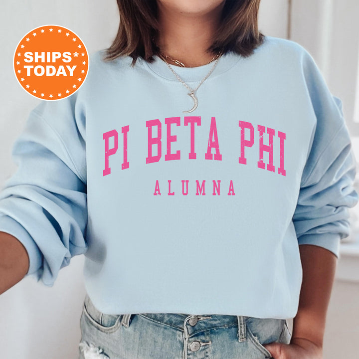 a woman wearing a blue sweatshirt with pink letters on it