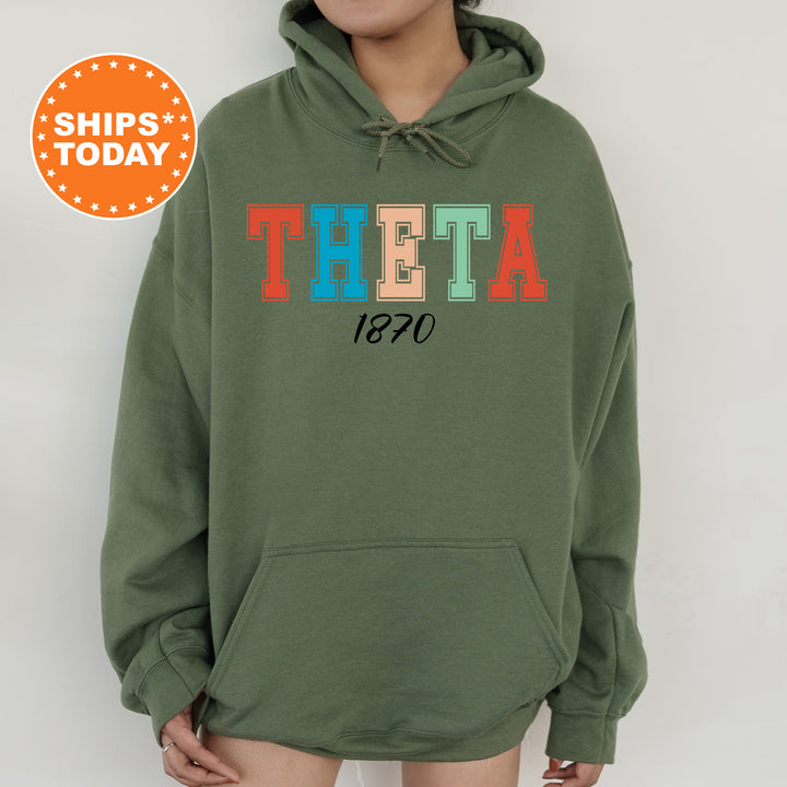 a woman wearing a green sweatshirt with the word thea printed on it