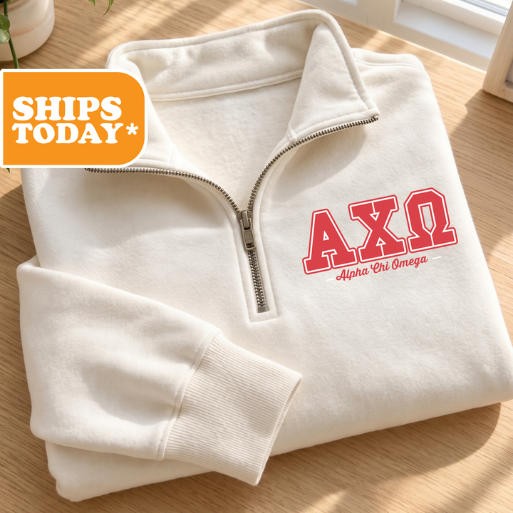 A white zip-up jacket with the letters "AXQ" printed on it, placed on a wooden surface.