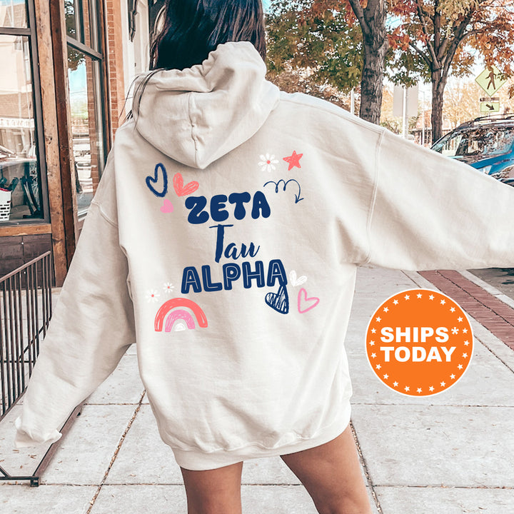 a woman walking down a sidewalk wearing a white hoodie