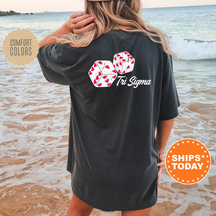 a woman standing on a beach wearing a black shirt