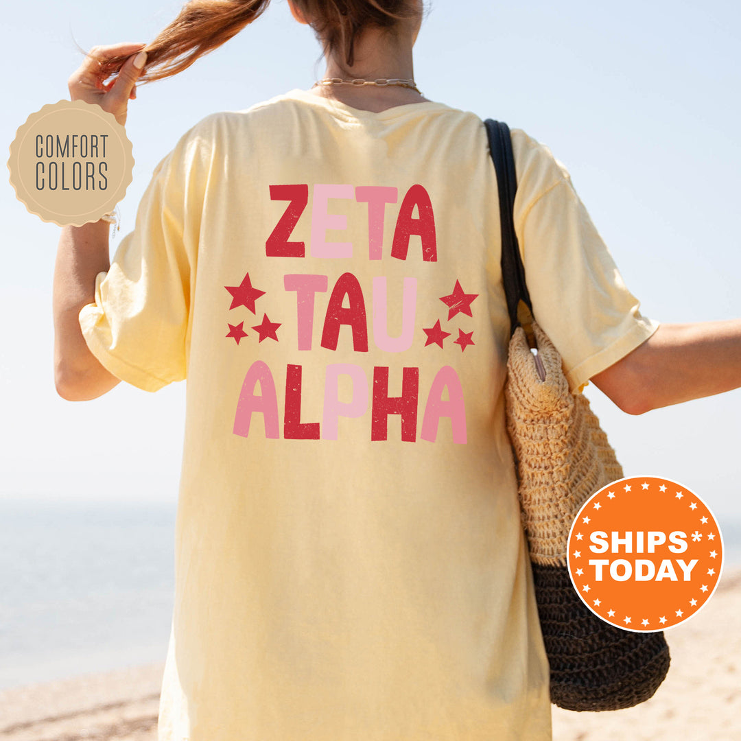 a woman walking on the beach with a t - shirt that says zeta tal