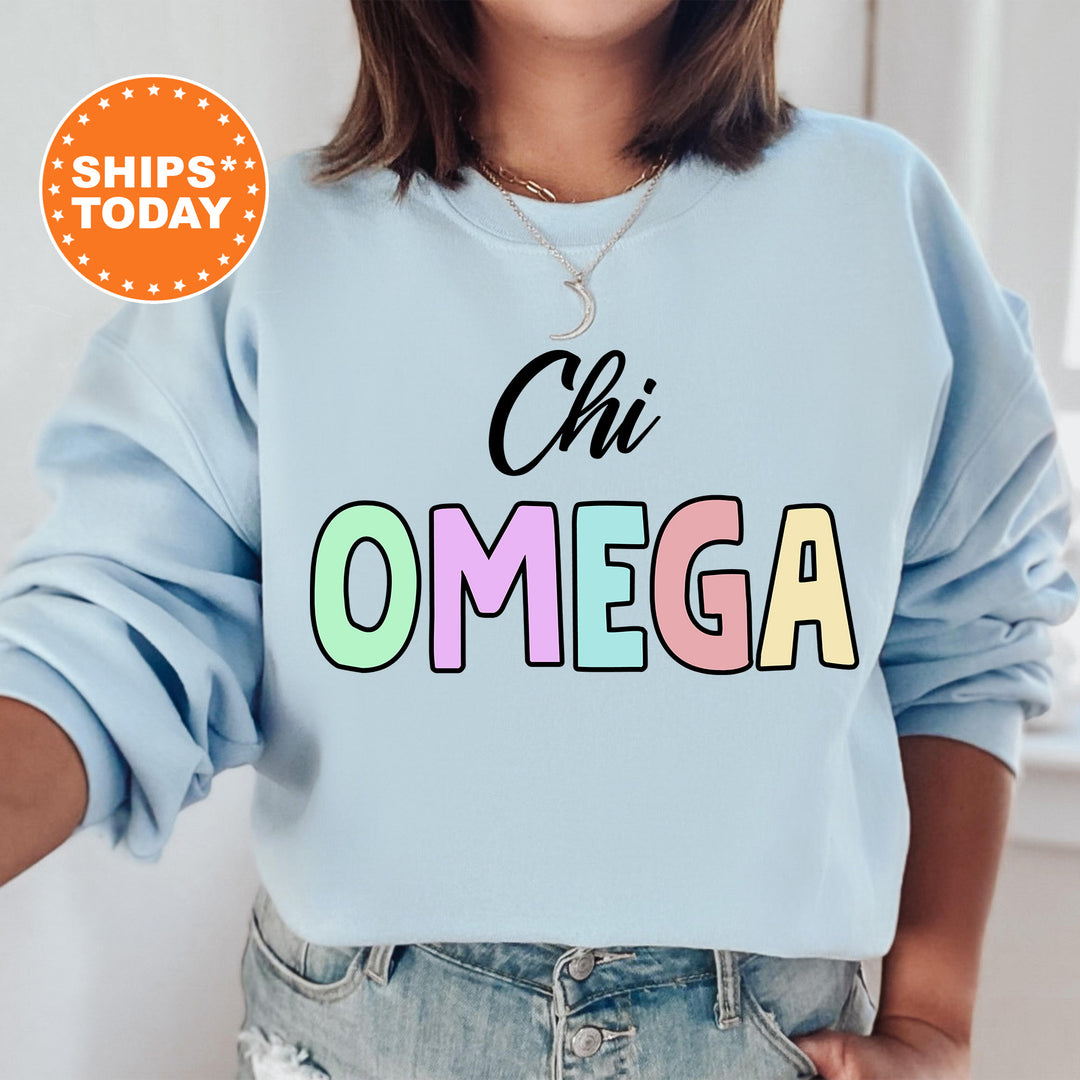 a woman wearing a light blue sweatshirt with the words oh omega printed on it