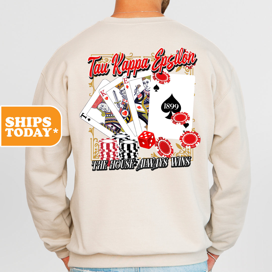a man wearing a sweatshirt with a picture of playing cards on it
