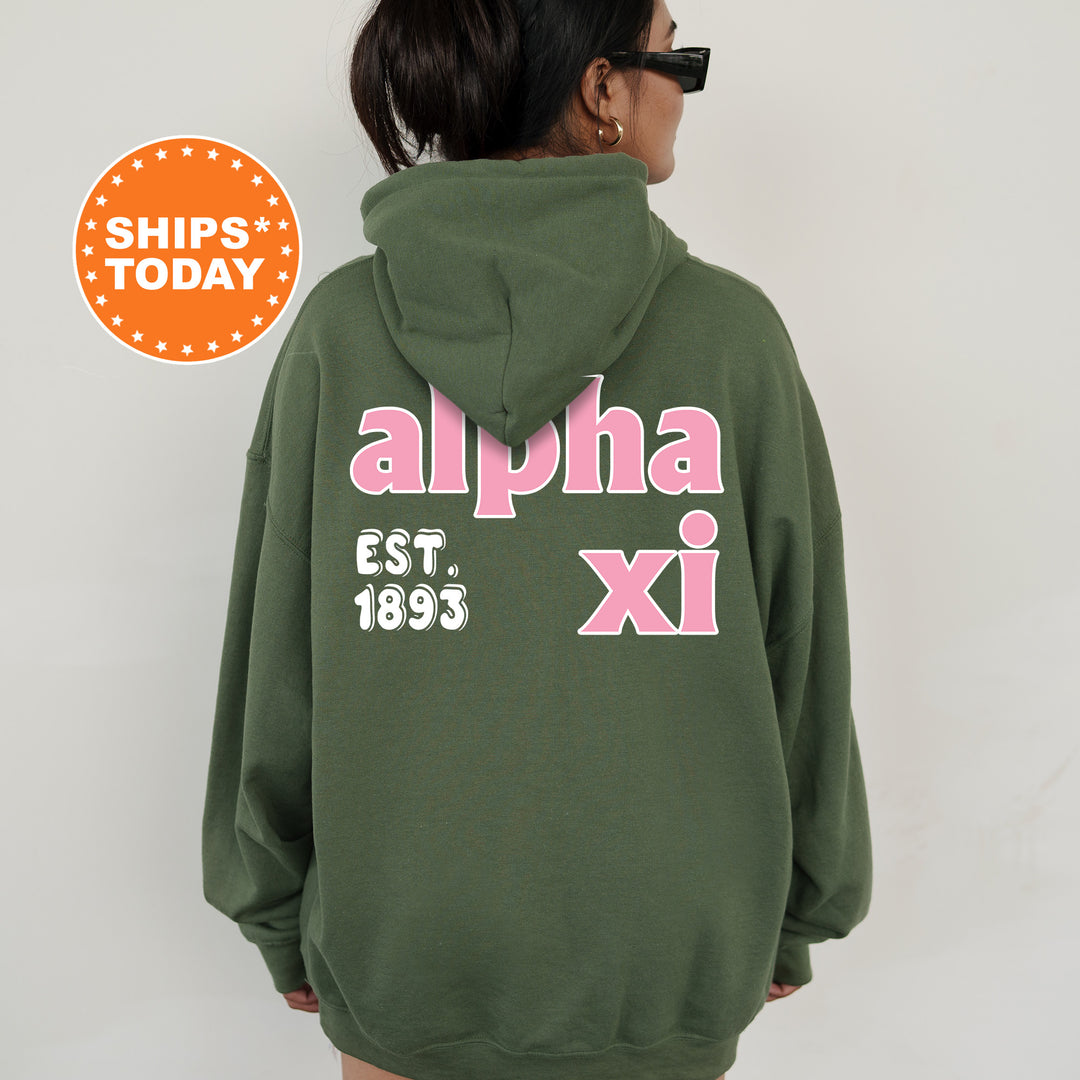 A person wearing a green hoodie with pink text and numbers on the back.
