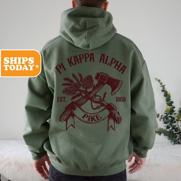 a man in a green hoodie with a hammer and axe on it