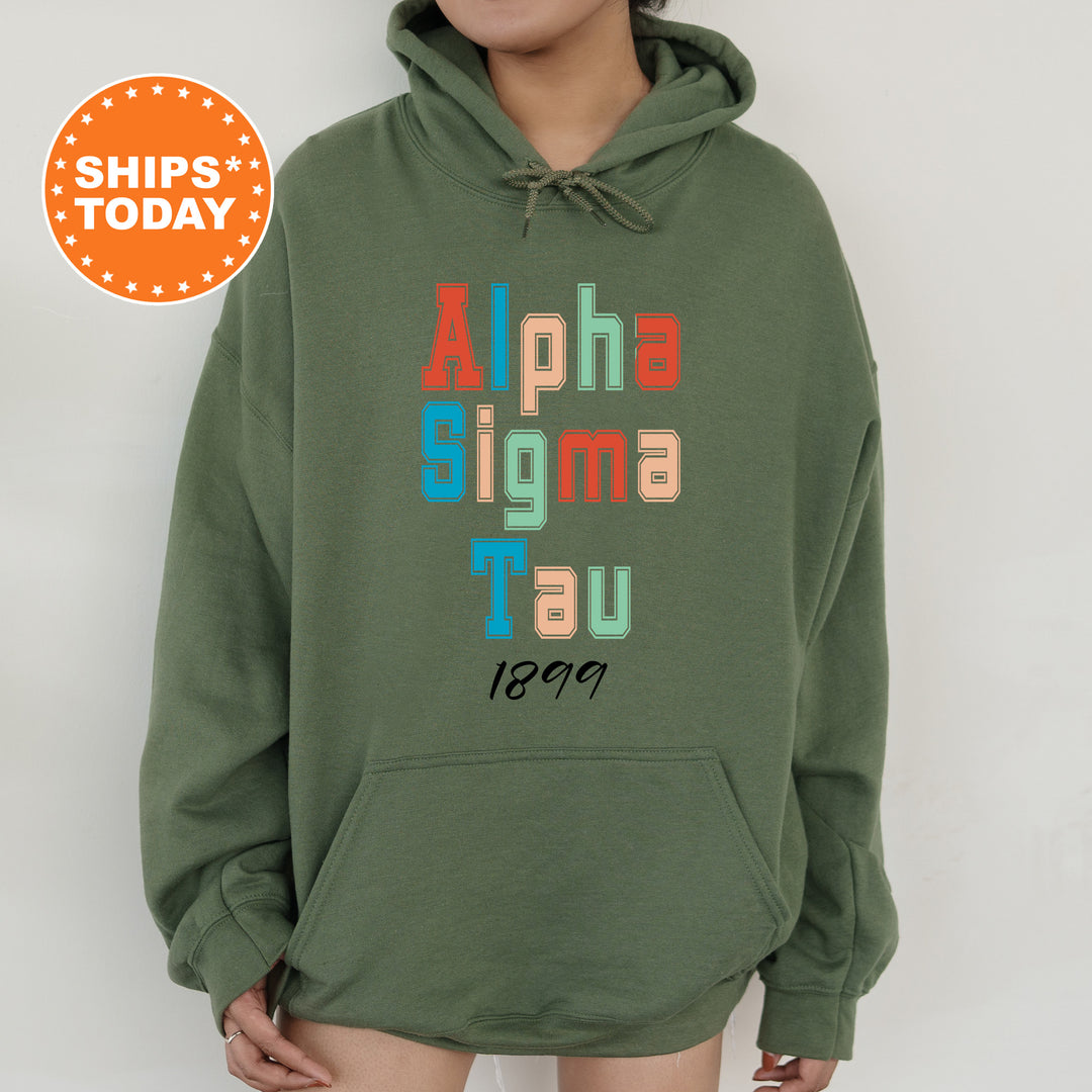 a person wearing a green hoodie with the words alpha sigmma