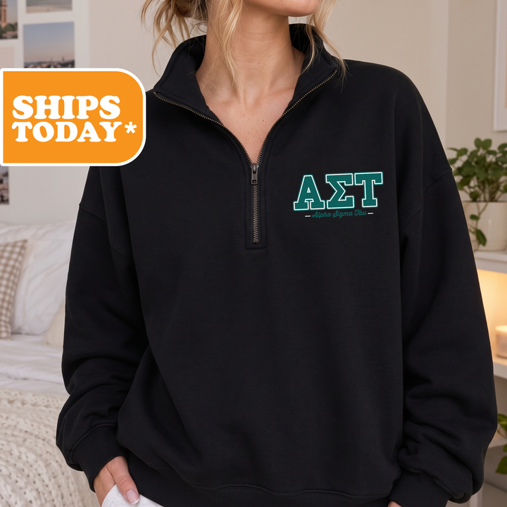 A person wearing a black sweatshirt with the Greek letters 'ΑΛΑ' printed on it.