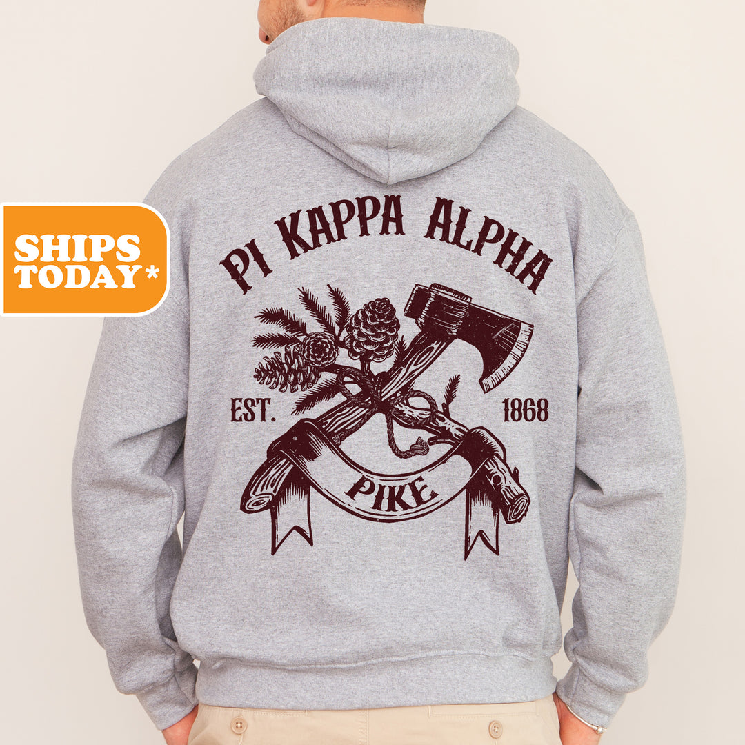 a man wearing a hoodie with a hammer and pine tree on it