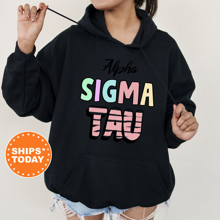 a woman wearing a black hoodie with the word stigma taq on it