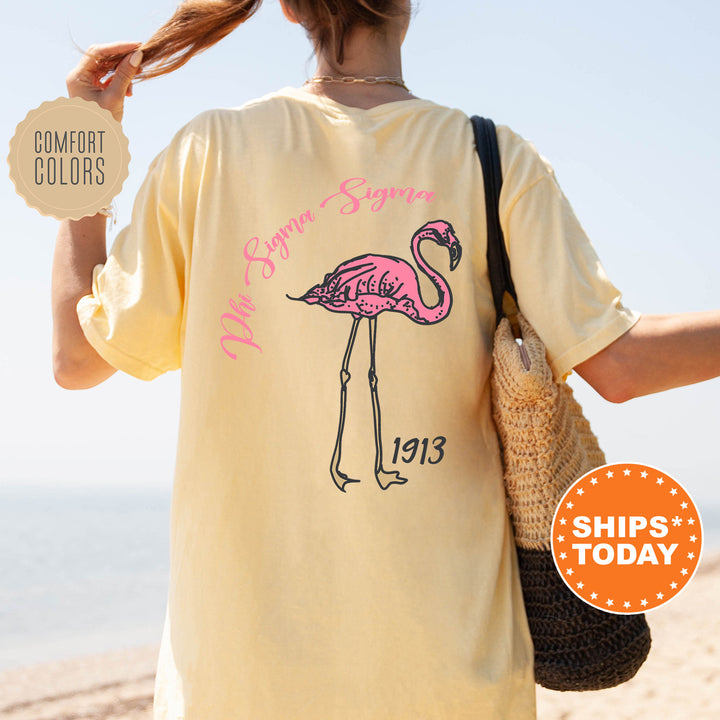 a woman with a pink flamingo on a yellow shirt