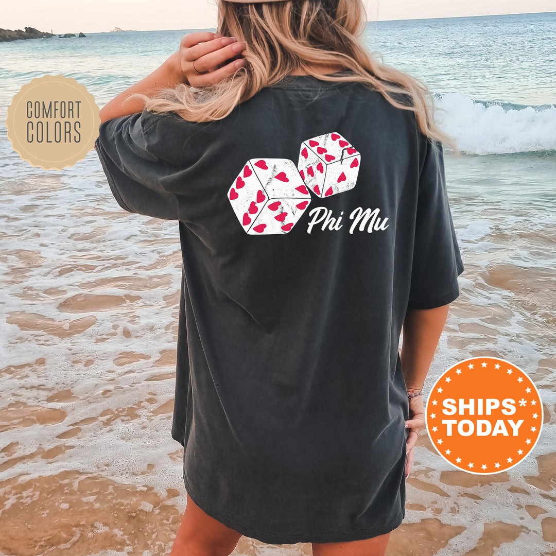 a woman standing on a beach wearing a black shirt