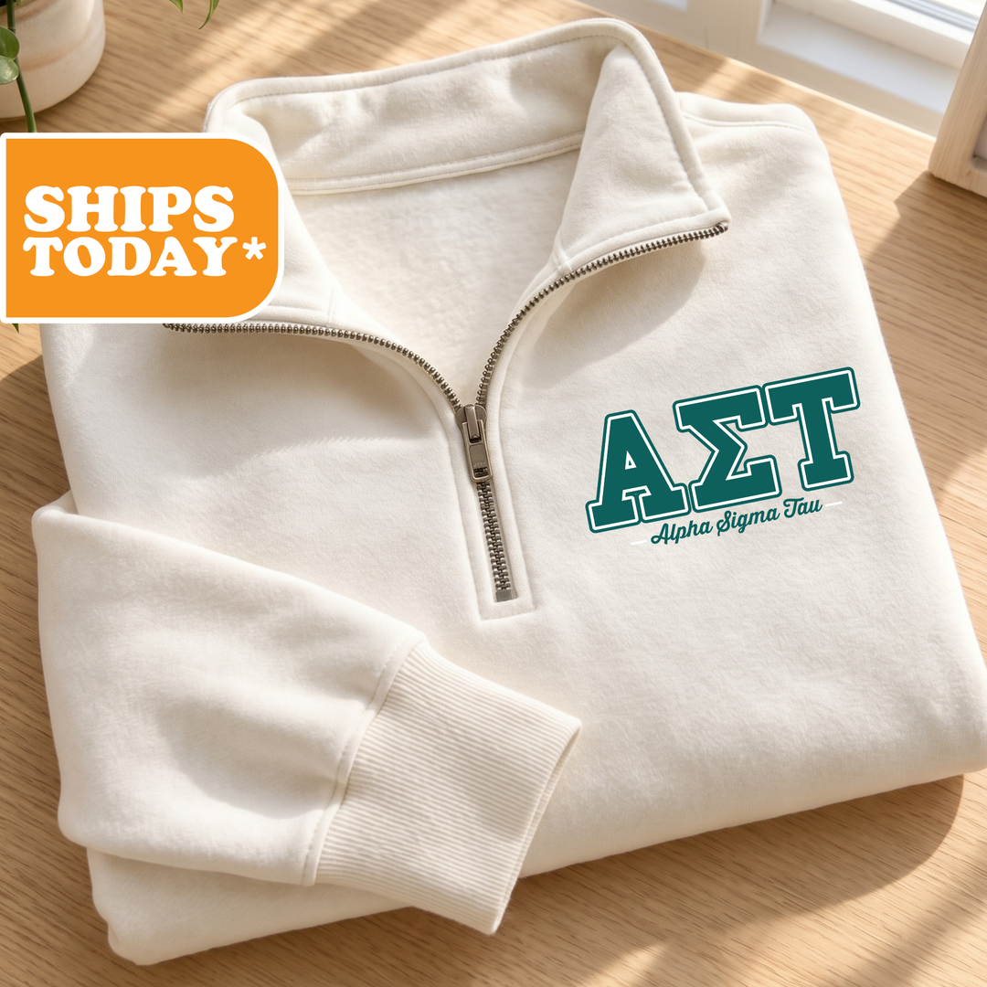 A white zip-up jacket with the Greek letters 'ΣΛΙ' printed on it, placed on a wooden surface.