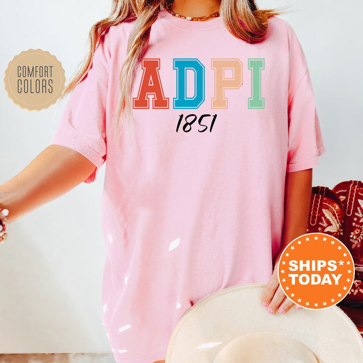 a woman wearing a pink shirt with the word adpi printed on it