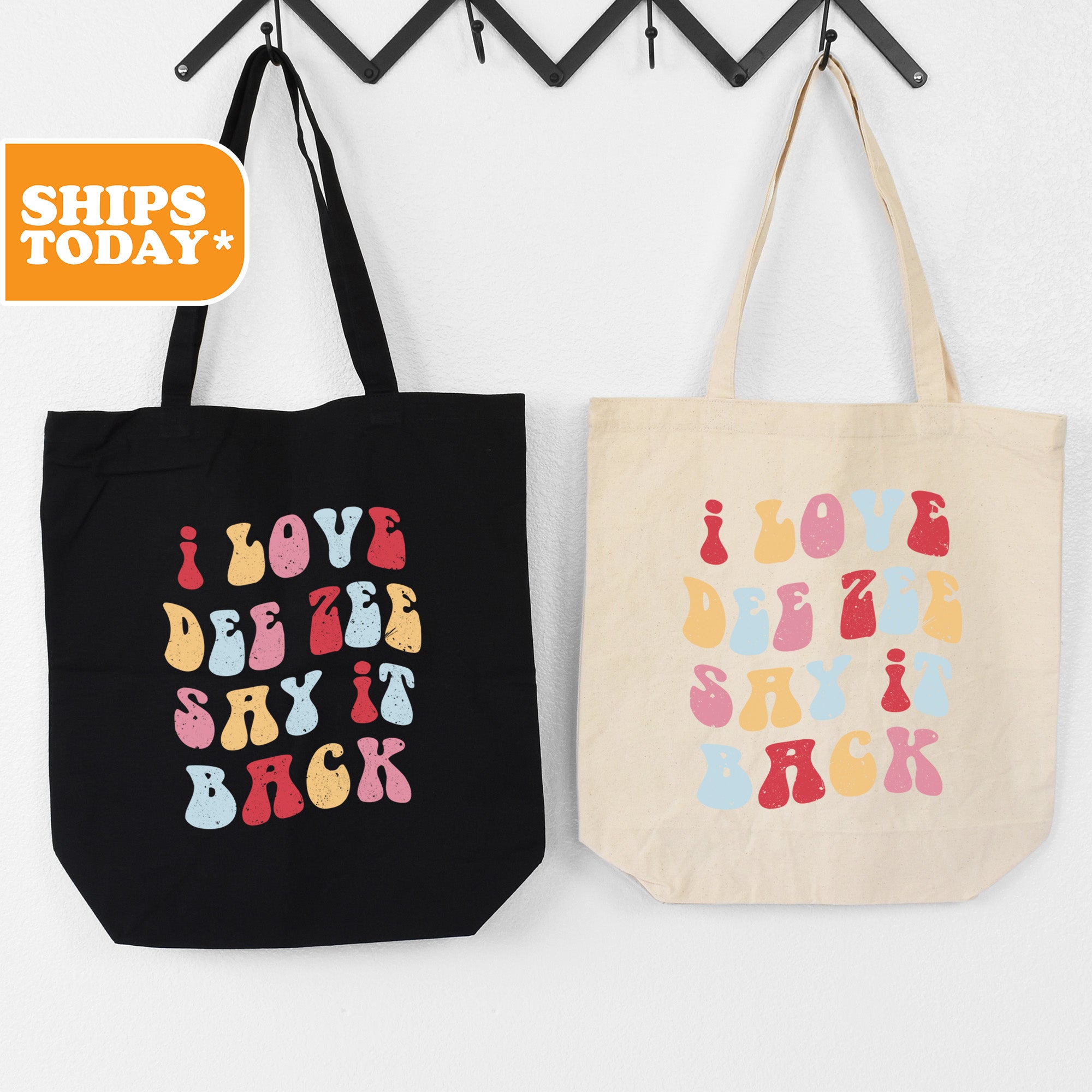 two shopping bags hanging on a wall
