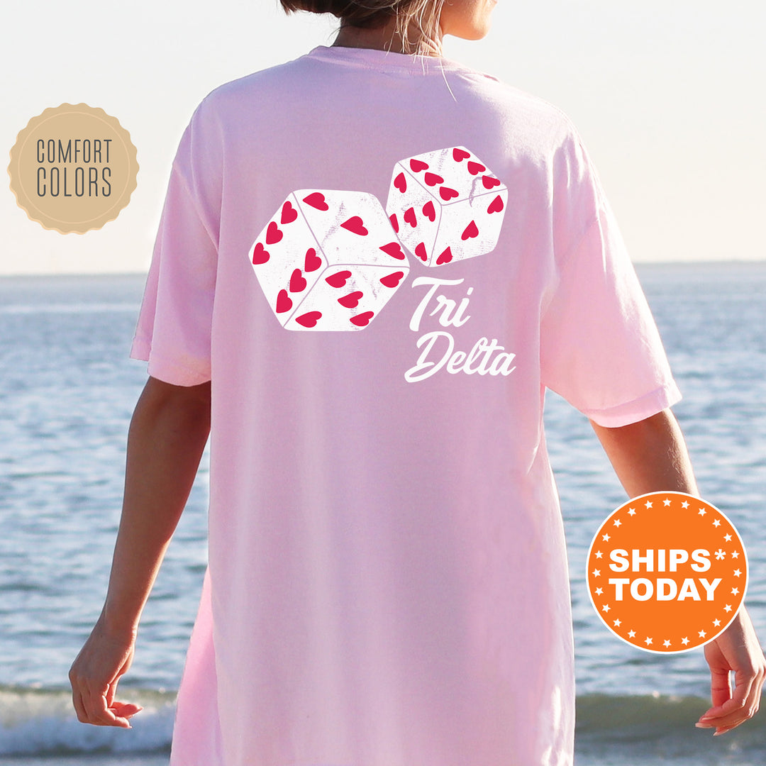 a woman standing on a beach wearing a pink shirt